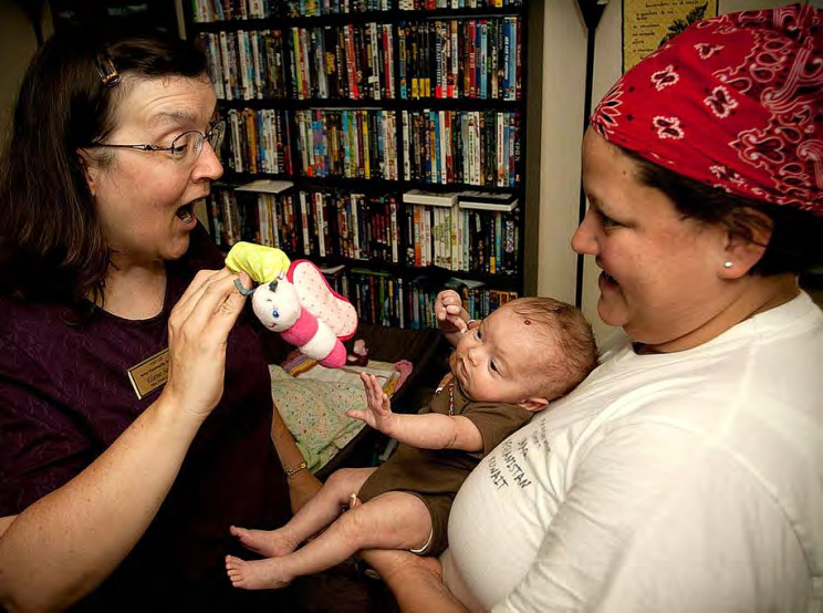 Roma mother with baby and healthcare worker